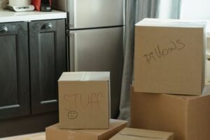 Packed moving boxes in a kitchen, a reminder that NDIS medium term accommodation is for the wait before moving home